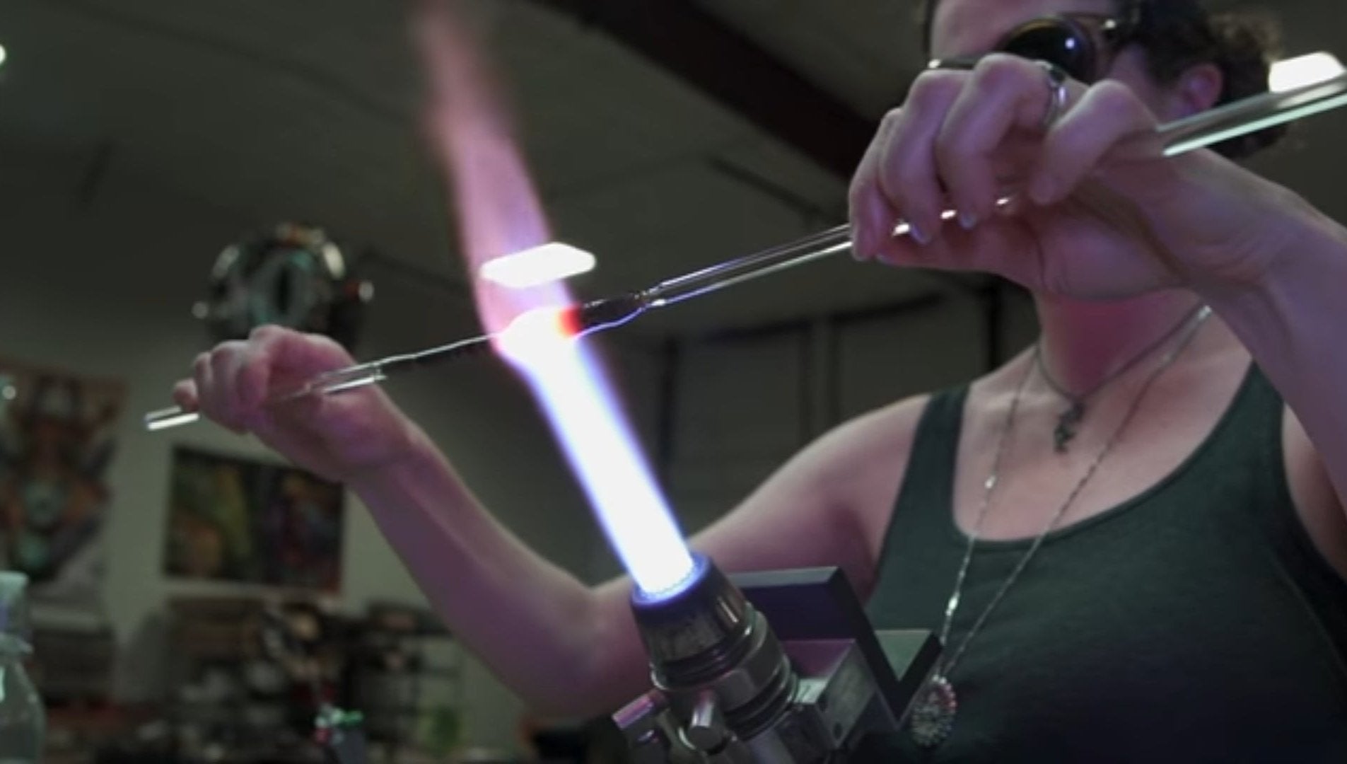 Annie Woods blowing glass on a Bethlehem PM2D bench mounted torch, making a glass sleeping kitty