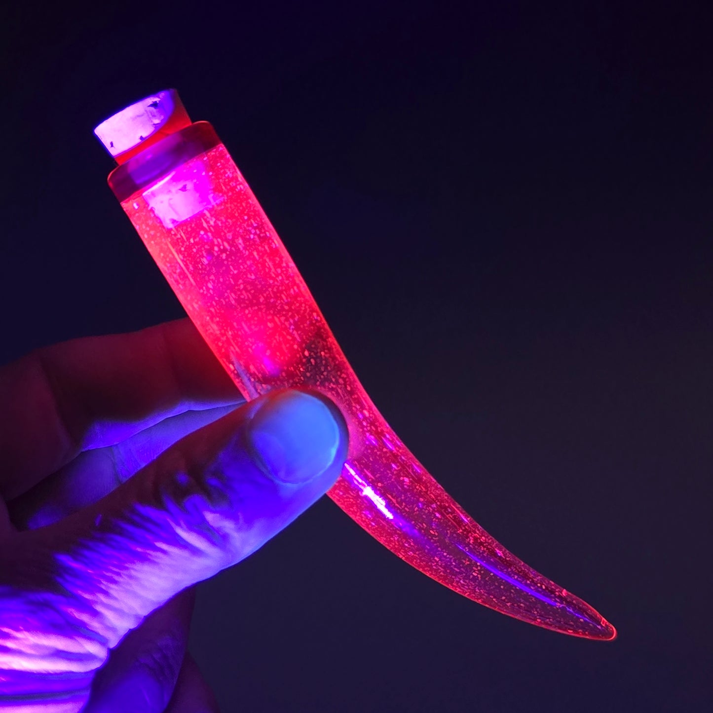 Glowing pink under blacklight, this whisker shaped hand blown glass jar with cork is a safe place to keep the fallen whiskers you find 