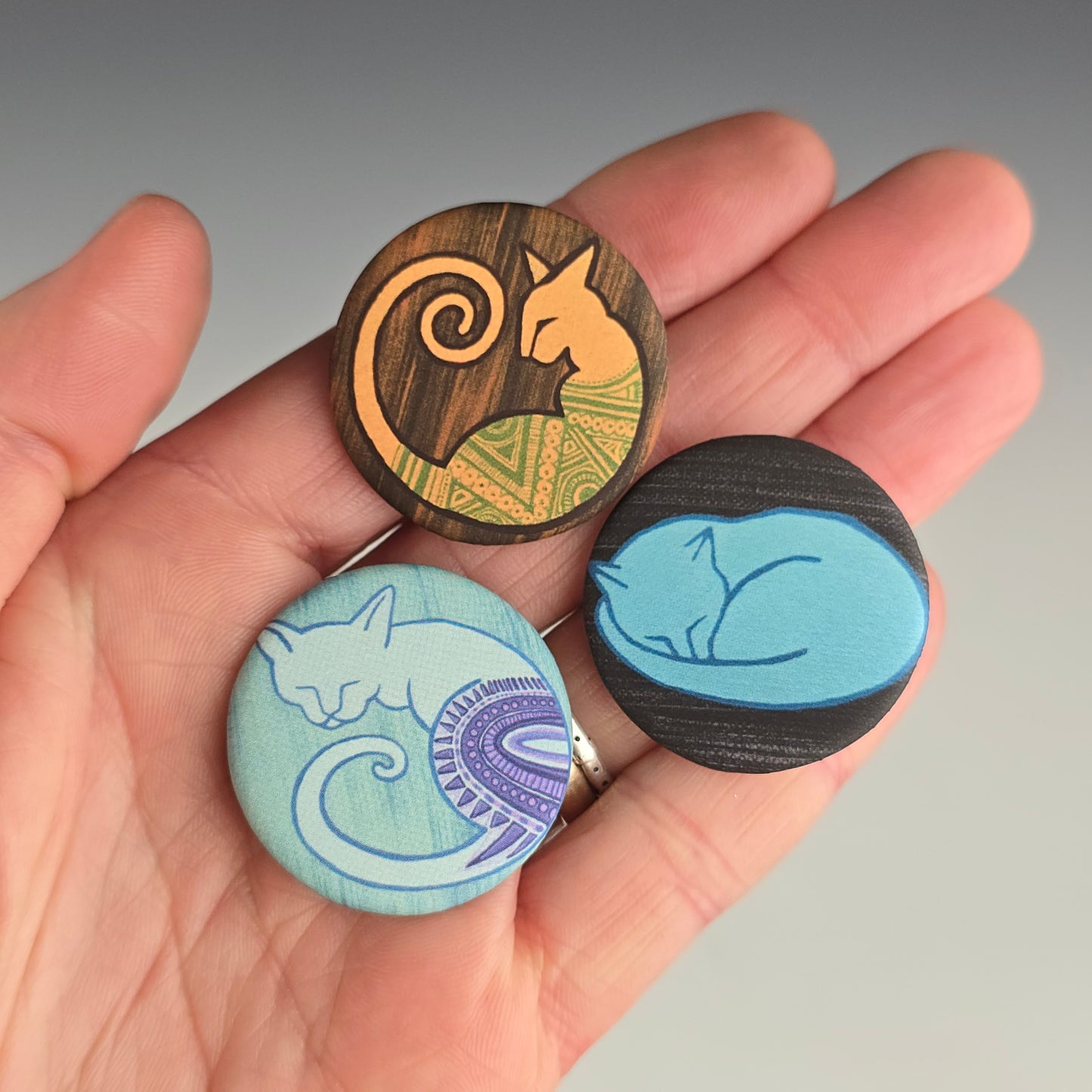 Soft matte textured buttons with images of colorful cat paintings by Annie Woods