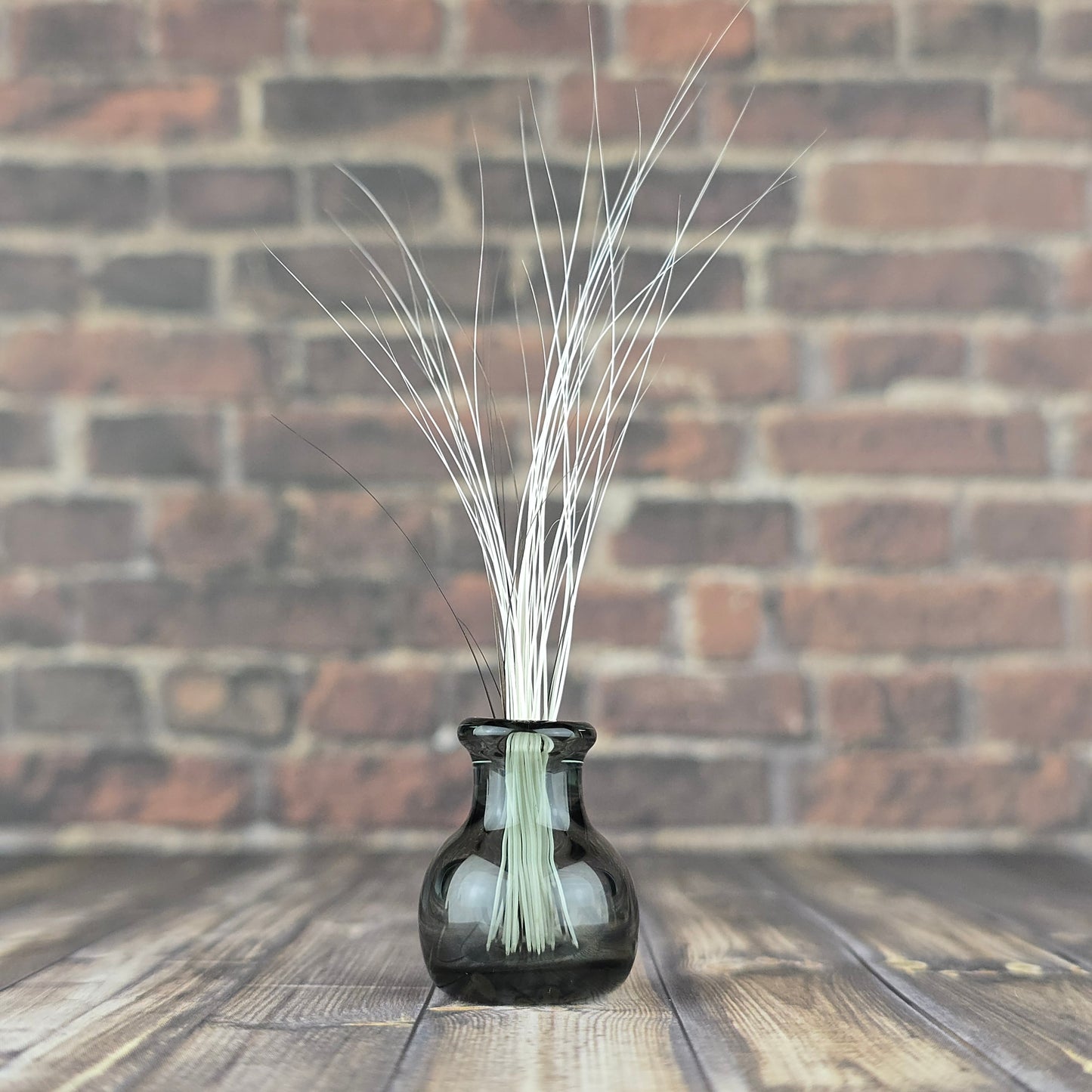 Miniature translucent glass vase filled with found fallen cat whiskers