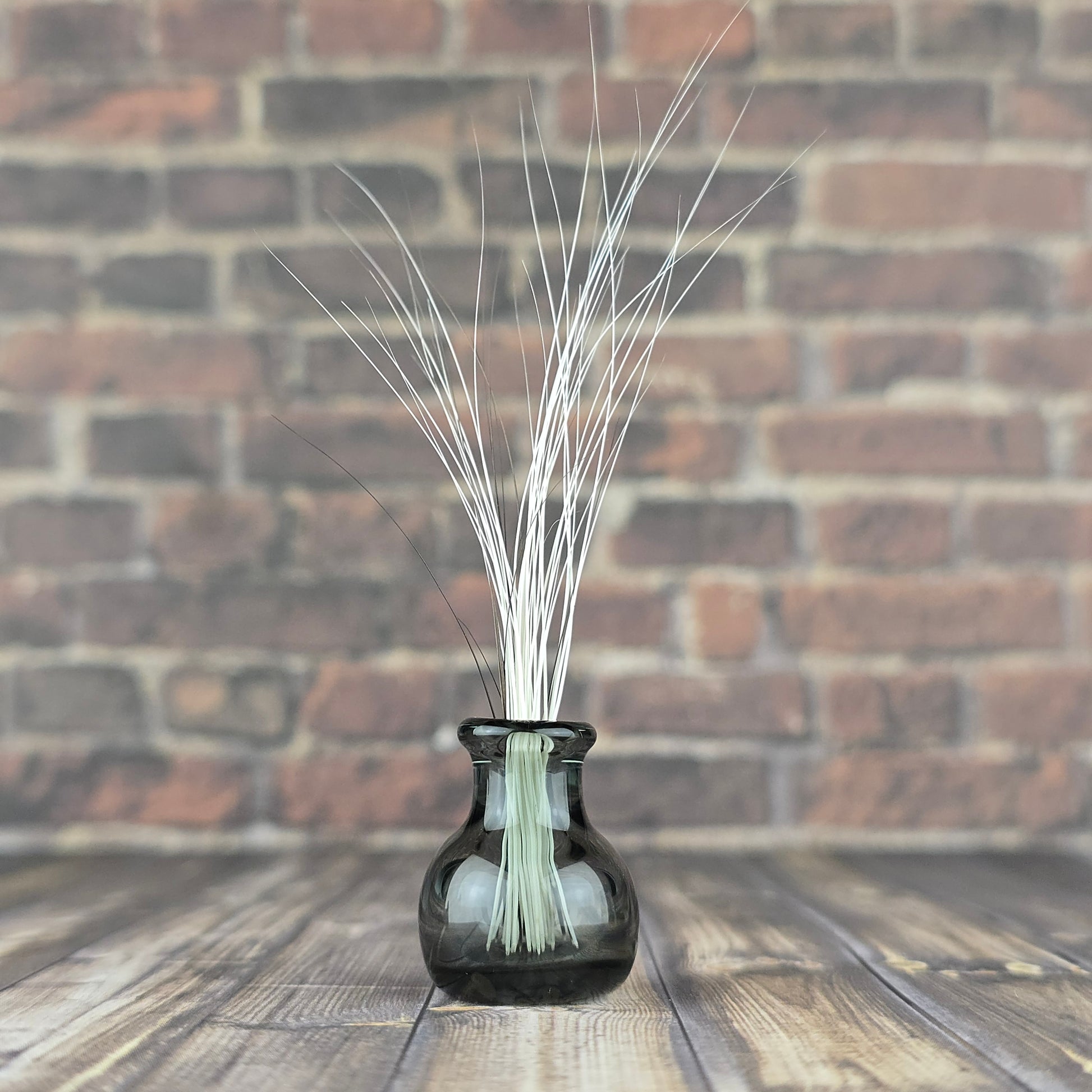 Miniature translucent glass vase filled with found fallen cat whiskers