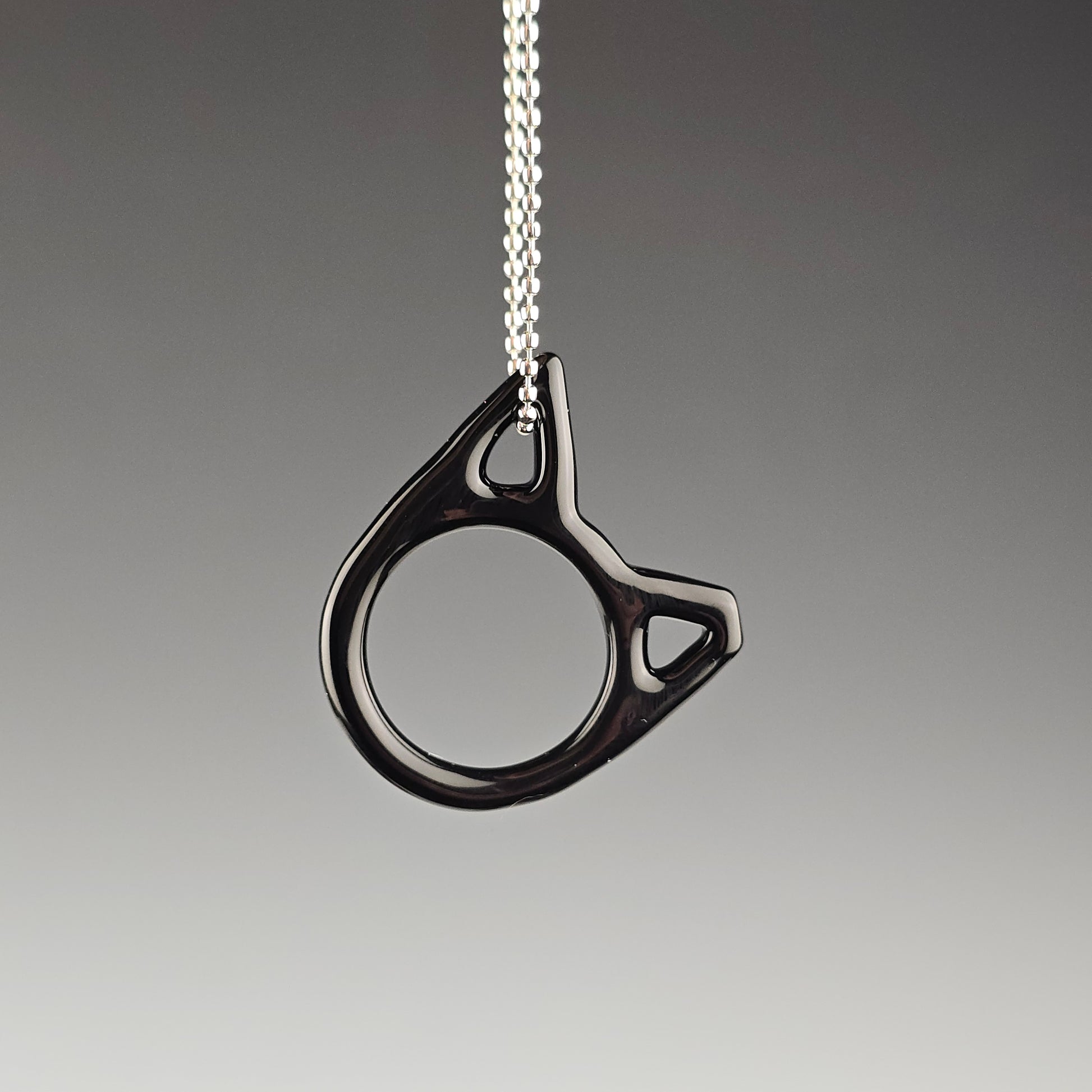 Black handmade glass cat necklace with one ear tipped representing TNR trap neuter return