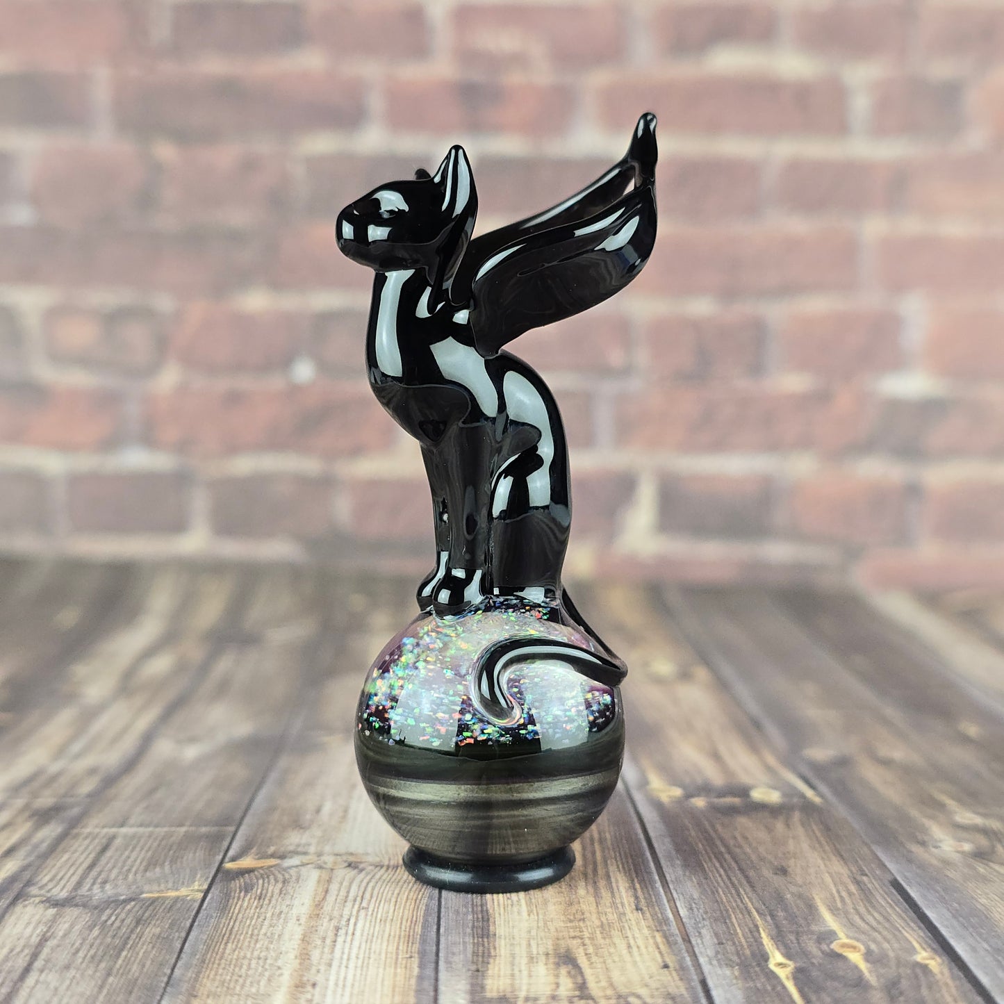 black winged cat sitting on a marble made with molten aura electrum and crushed opals