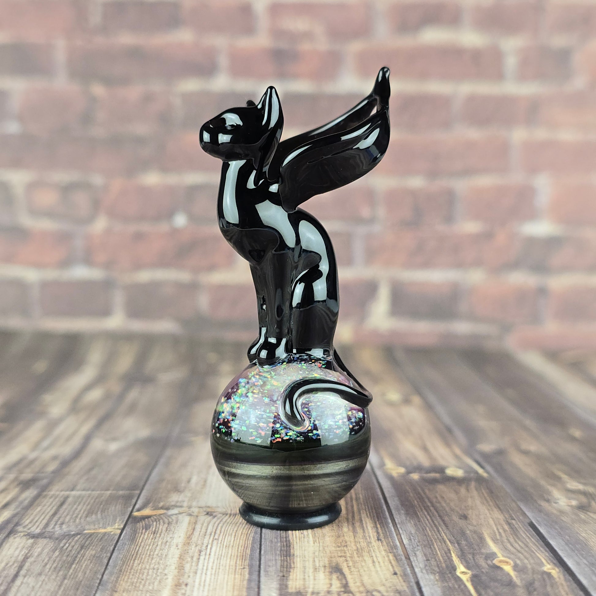 black winged cat sitting on a marble made with molten aura electrum and crushed opals