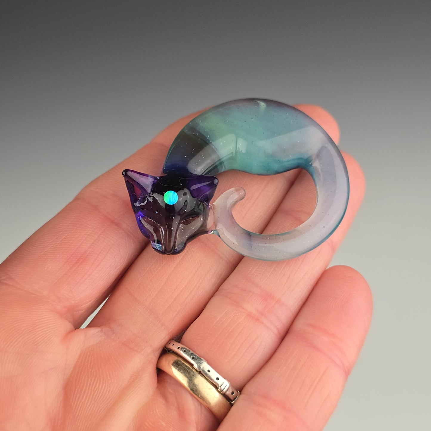 glass sleeping kitty necklace with a bright opal sphere in the third eye