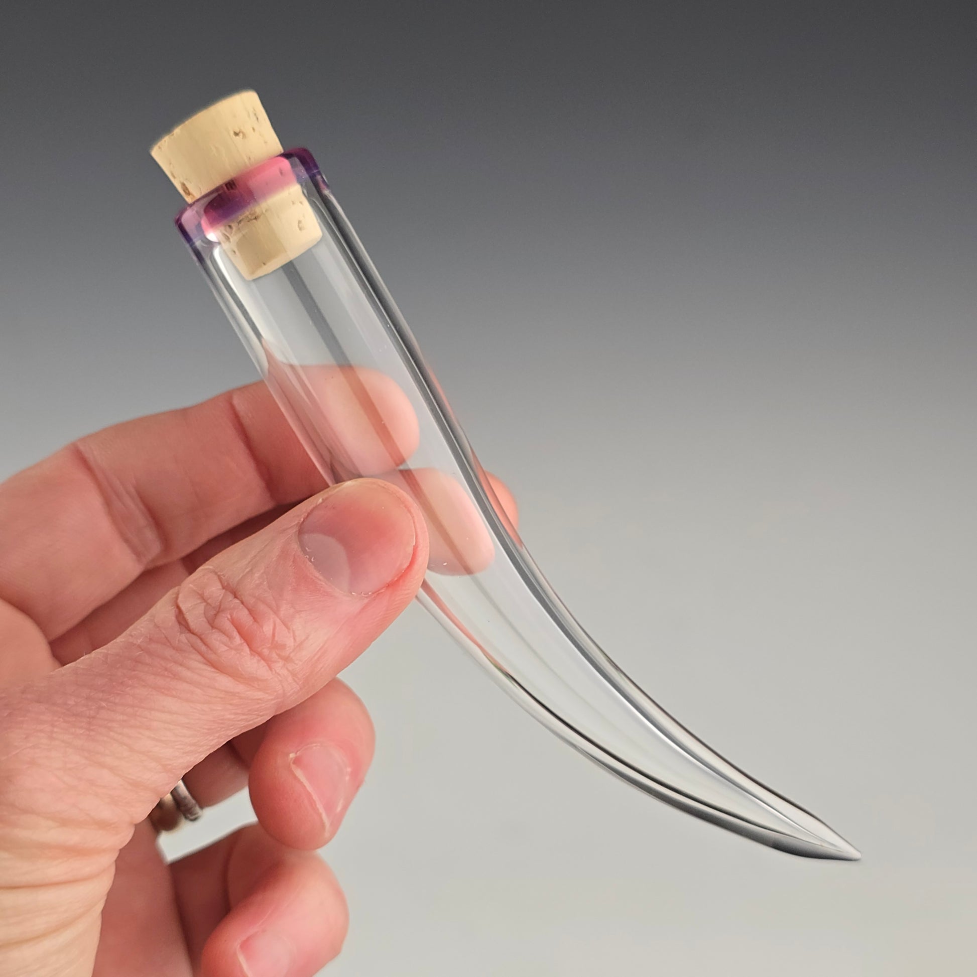 Keep the fallen whiskers you find safe inside this small hand blown whisker shaped jar made out of clear glass with a Royal Jelly purple color accent around the corked opening.