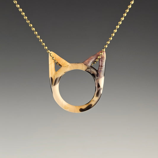 Tabbico tabby calico glass kitty face necklace hanging on a brass ball chain